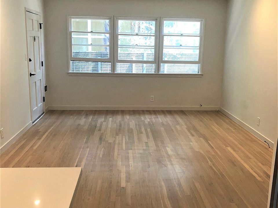 Living room windows looking from kitchen. LED recessed lights to side walls for art.