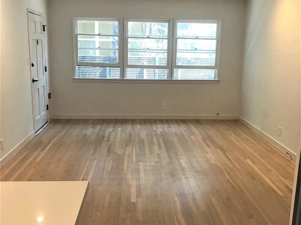 Living room windows looking from kitchen. LED recessed lights to side walls for art.