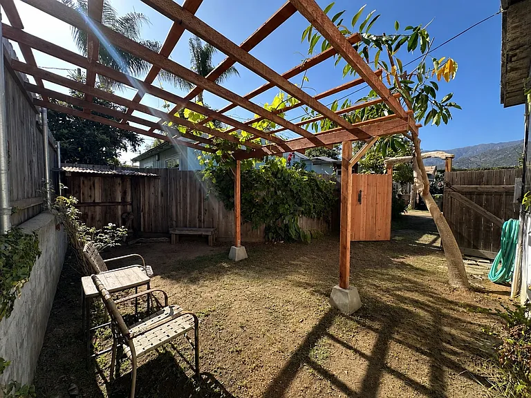 Private, gated yard with pergola