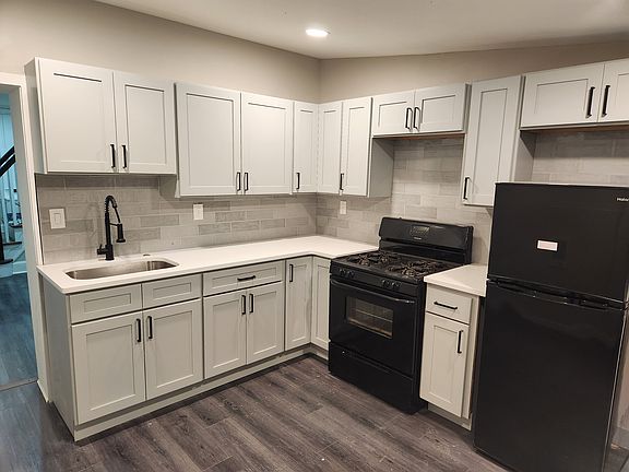 Renovated kitchen with expansive cabinetry, counters, and recessed lighting
