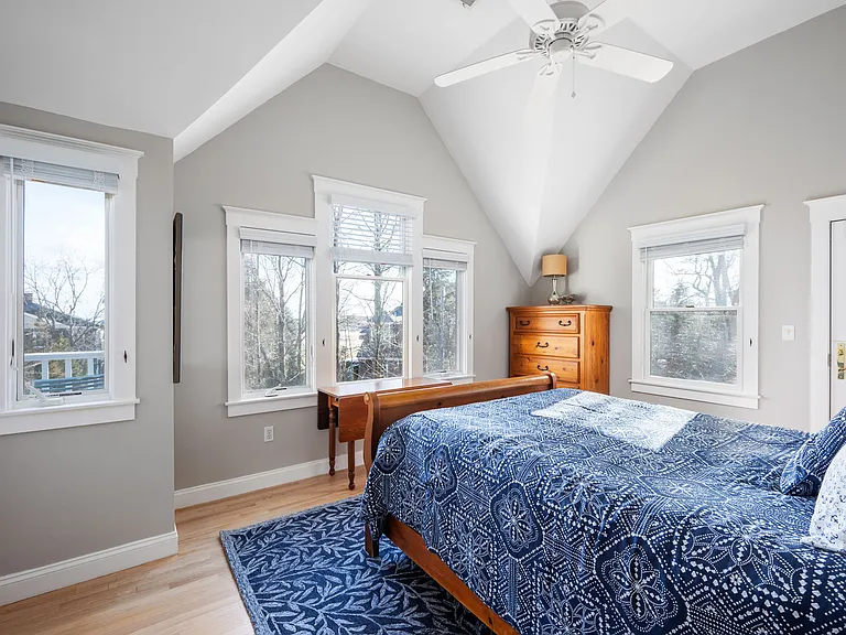 Right front master bedroom with queen bed, ocean views, vaulted ceiling, ceiling fan, large closet, and door to screened porch.