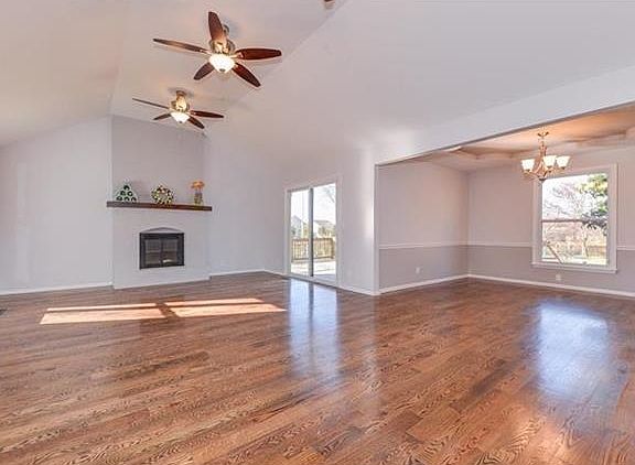 VIEW OF LIVING ROOM AND DINING ROOM TO THE RIGHT.