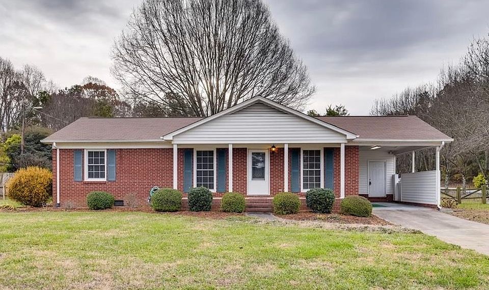 Brick ranch with carport on level, corner lot.