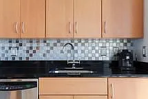 custom glass tile backsplash above granite countertop