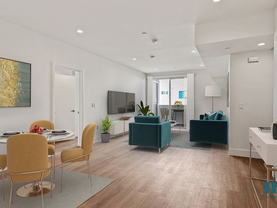 Open-Concept Dining, Living Room, and Patio with Recessed Lighting and Vinyl Flooring
