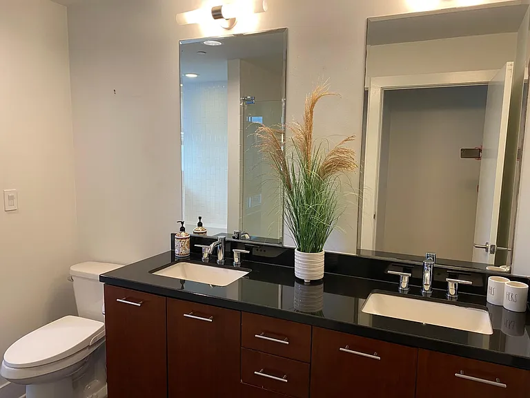 Dual sink and bidet in large bathroom.