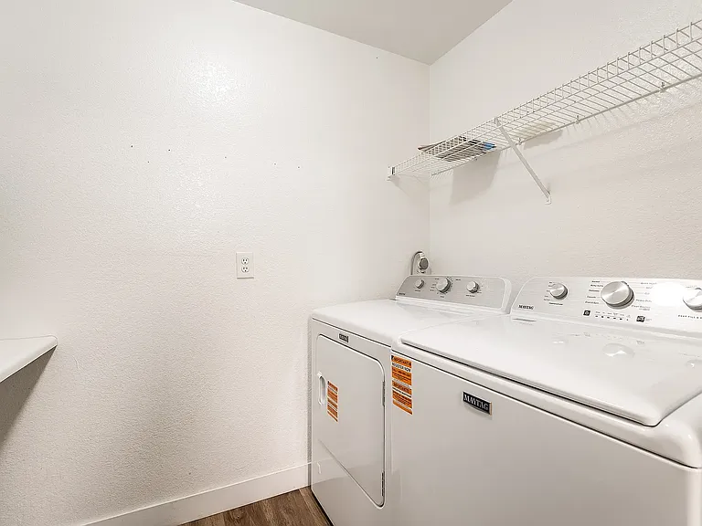 Separate Laundry Room with storage and folding counter, New Washer & Dryer.