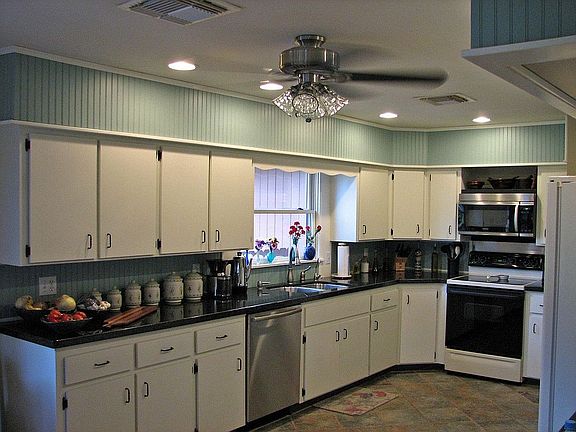 Granite Countertop and Porcelain Tiles enhance this Warm Kitchen