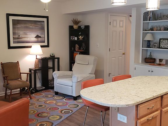 Den, with hallway connecting to front entry.