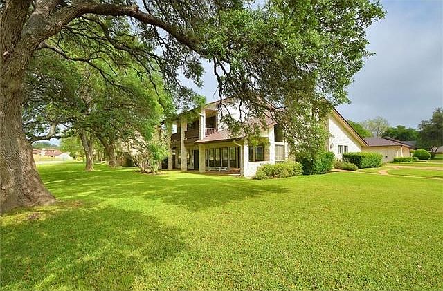 Gorgeous home overlooking the Onion Creek Golf Course, and surrounded by Heritage Oaks.