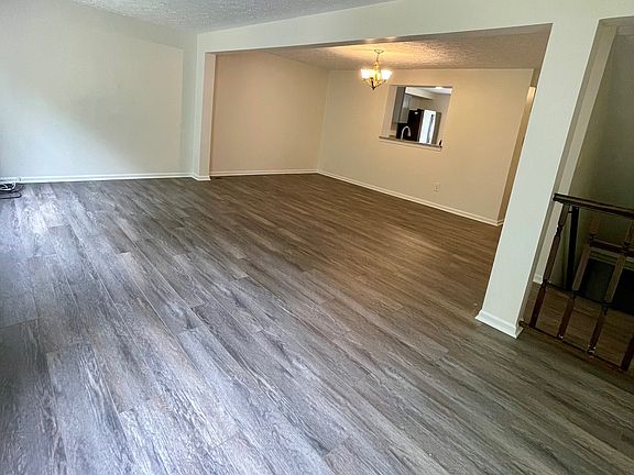 Living and dining room with new wooden flooring.