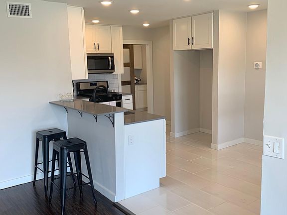 OPEN KITCHEN AND DINNING AREA LOOKING INTO THE LAUNDRY ROOM