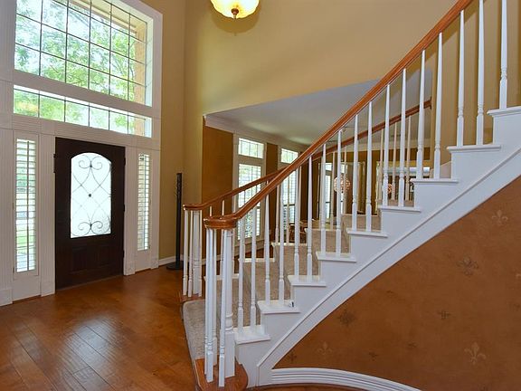 View of the two story entry. Beautiful wood floors in entry, formal, and the dining room..