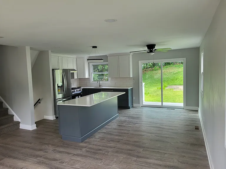 upper level living space with full kitchen appliances and easy access to rear yard