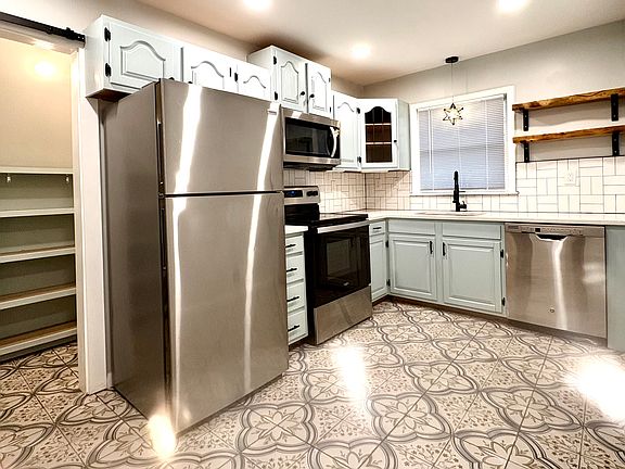 Spanish concrete tile, stainless steel appliances and granite countertops