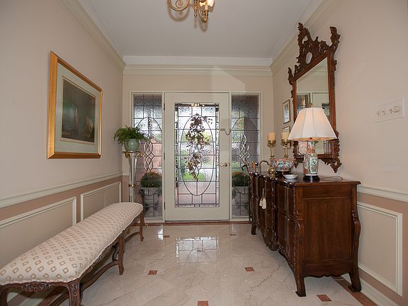 Beautiful lead glass doors open to gorgeous marble entry