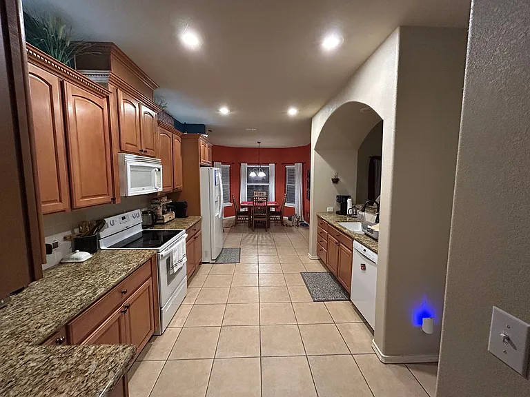 Custom cabinetry with granite countertops and appliances
