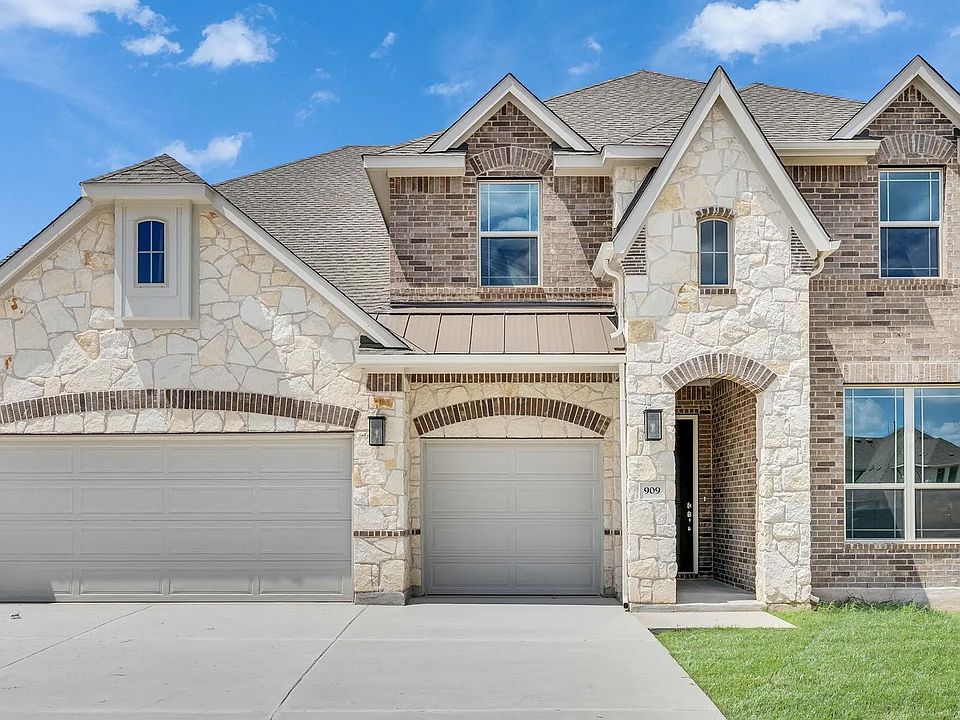 Exquisite stone facade, arched entries, and refined shutters define this Hawkes Landing masterpiece.