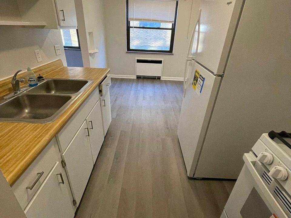 Galley kitchen with new appliances, floor, paint, fixtures.