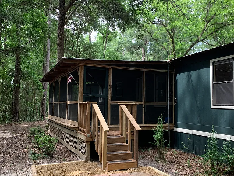 Entranceway to large screened in front porch.