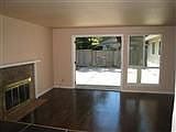 Fireplace and frenchdoors opening to patio area and backyard