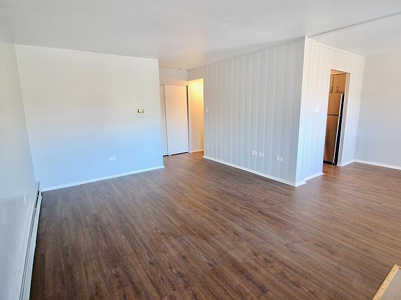View from front door. Dining room and kitchen to the right, hallway to bedroom and bathroom in the back.