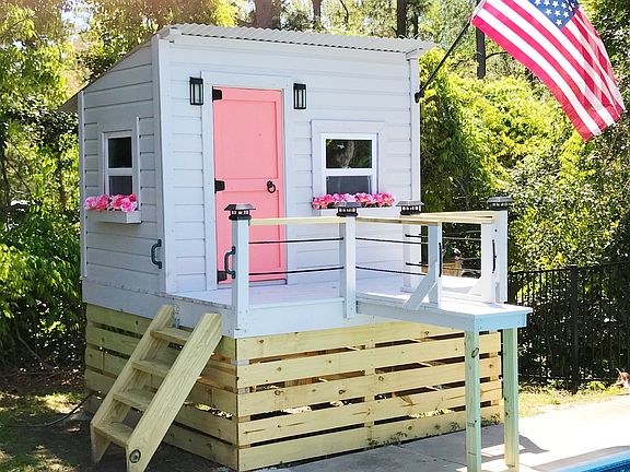 Kids playhouse by pool