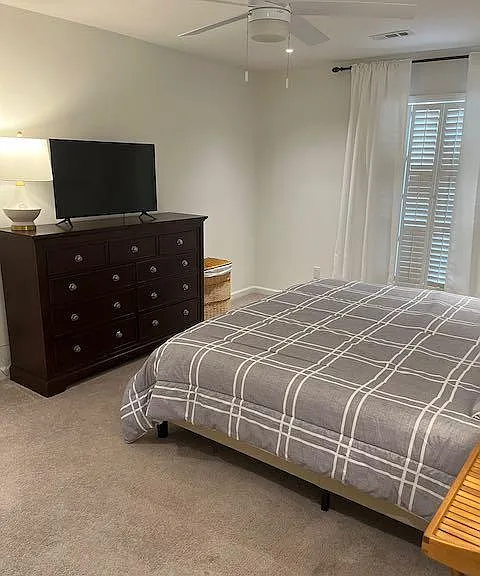 The master bedroom has a king size bed, dresser and television set. The carpets are new and there is a large walk-in closet with shelving, and room for full length dresses and coats.