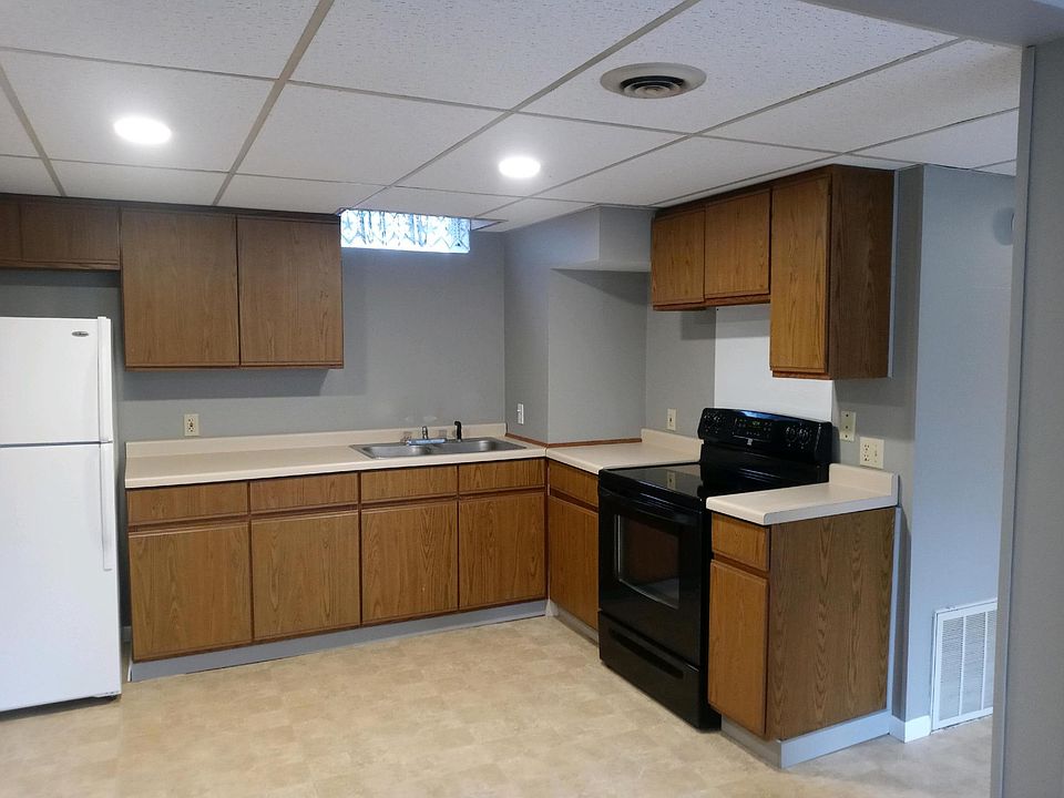 Cabinets and counters are being updated with new white cabinets and grey counter.