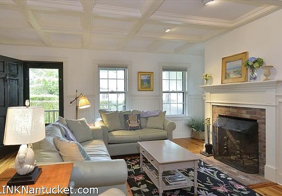 Living room with coffer-ed ceiling and fireplace