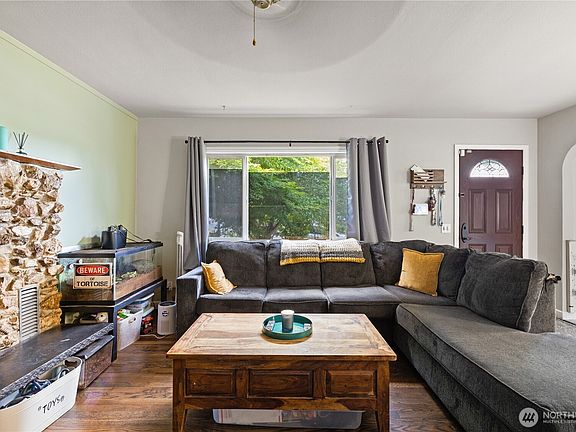 Cozy & inviting living room. Great natural light from large windows.>