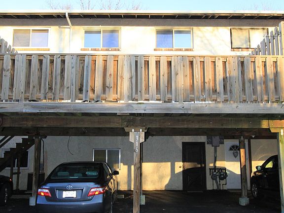 Back View of home with two assigned parking and Back Entrance