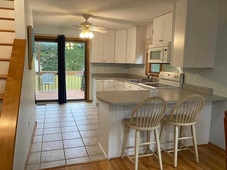 Kitchen, looking out to backyard. Recently renovated with tile floor and new appliances.