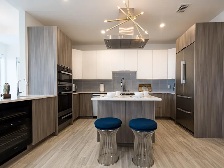 kitchen with stainless steel appliances and a bar to the left