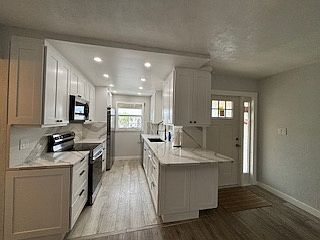Kitchen and entry way with new front door installed
