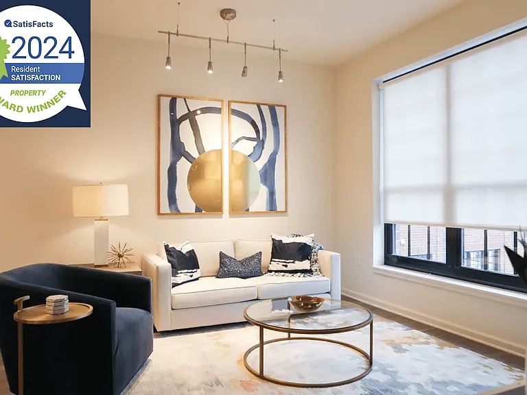 The Met Living Room Interior Image with Resident Satisfaction Award Logo Badge