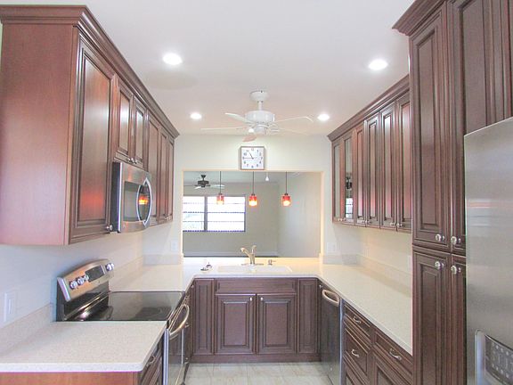Nice Updated Kitchen- Cherry Cabinets With Pantry Cabinet & Corian Countertops