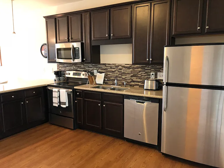 Kitchen with quartz countertops & stainless steel appliances