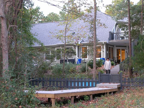 Rear house view with boardwalk to marsh.