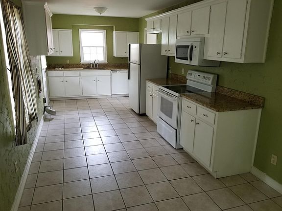 KITCHEN AND EATING AREA WITH GRANITE COUNTERS 