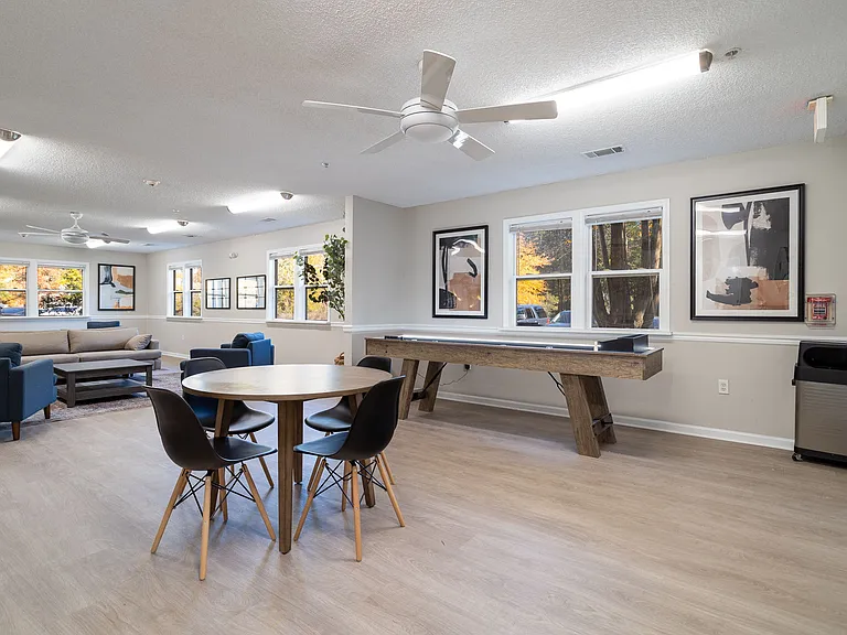 Enjoy our resident clubhouse featuring a shuffleboard table and comfortable lounge seating for entertaining, professionally operated by Highlands Vista Group.