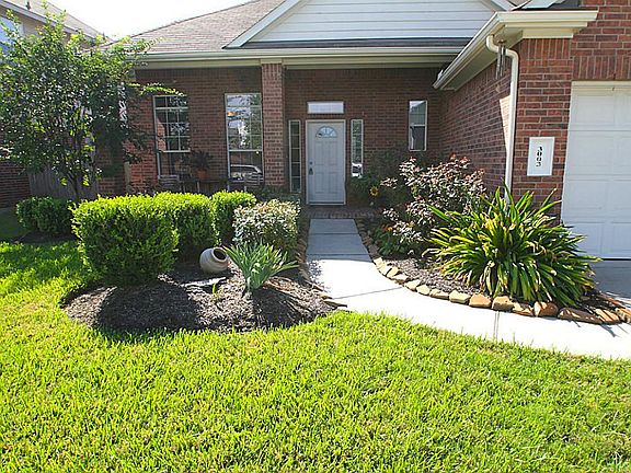 LAVISHLY LANDSCAPED ENTRYWAY