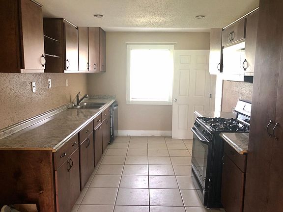 Spacious kitchen with granite countertops and gas stove