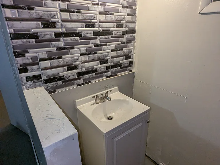 Basement sink behind bar