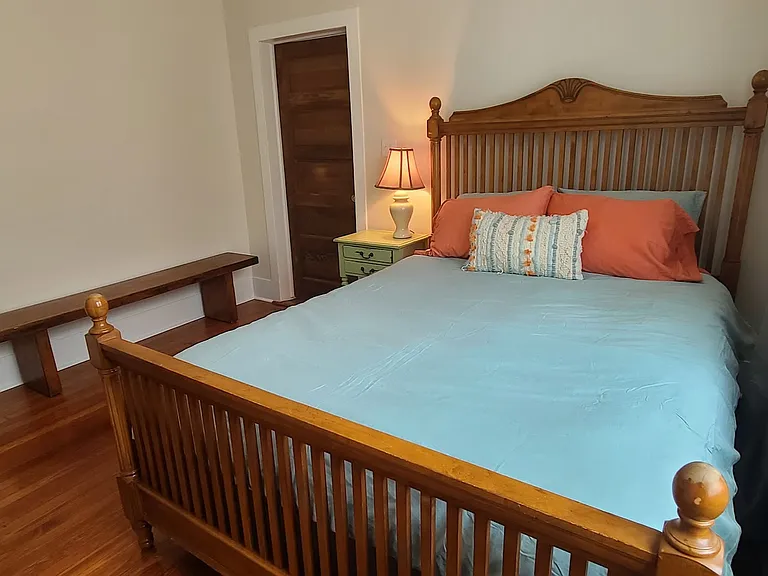 Queen bedroom with door to kitchen.