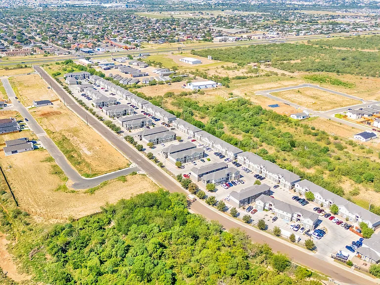212_Obsidian_D-6 - Aerial perspective of La Joya Apartments in Laredo, Texas, featuring a residential neighborhood with houses and landscaped areas
