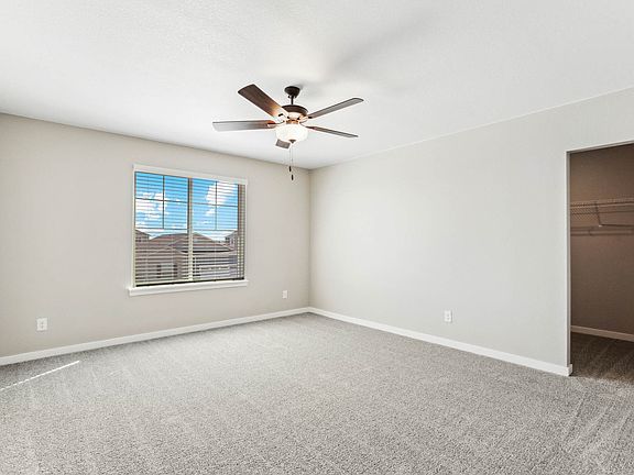 The master bedroom is spacious with a large window.