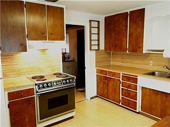 Kitchen has lots of cupboards and couter space with room for dining table.