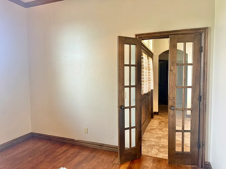 The home has a bonus library/office that is adorned with classic French doors.

Exquisite dark hard wood floors compliment the bookshelves on the opposite wall.