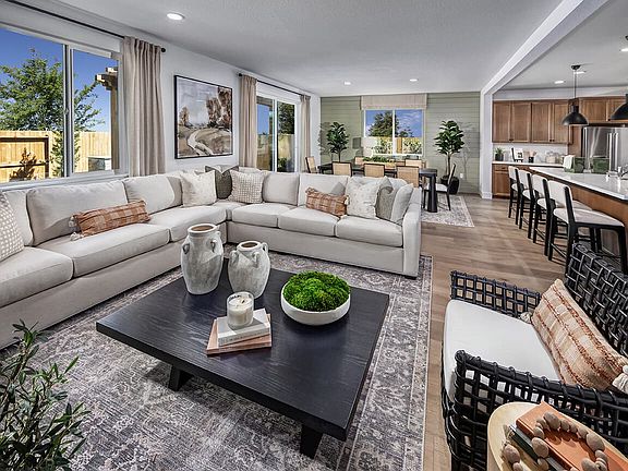 This open great room is bright, airy, and designed for connection. Expansive windows fill the space